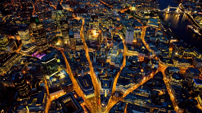 Aerial view of London skyline at night with Tower Bridge