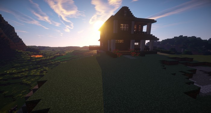 Minecraft house on a hill at sunset