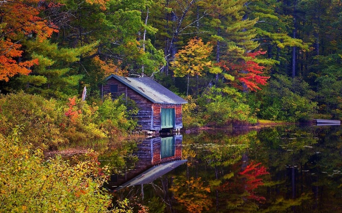 Wooden boathouse on a lake during autumn