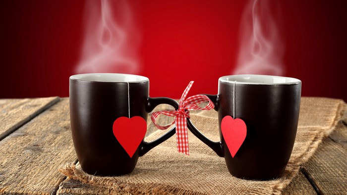 Two mugs with hearts and steam