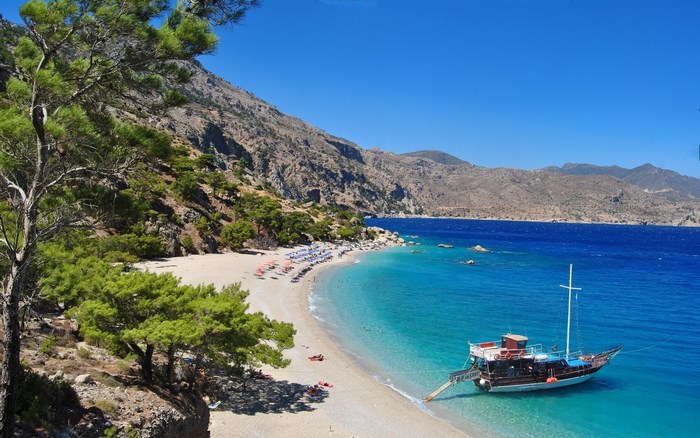 Secluded Beach with Clear Blue Water and Boat