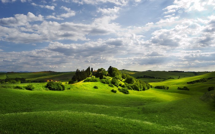 Green rolling hills with a house on top