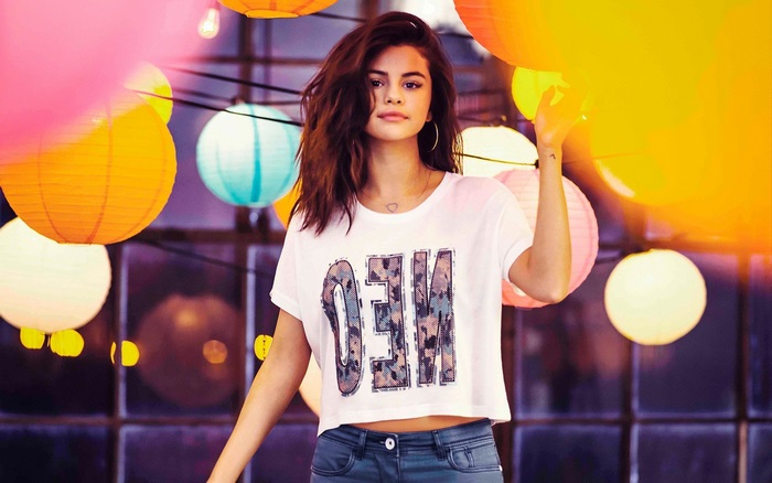 Selena Gomez in front of colorful lanterns