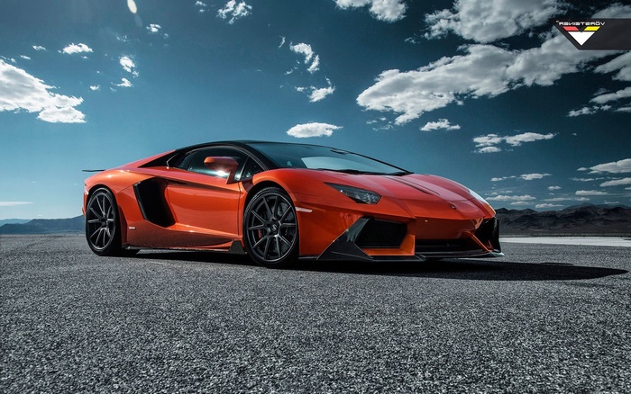 Orange Lamborghini Aventador on asphalt road