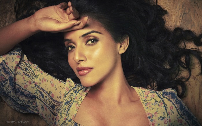 Asin lying down with hand on forehead