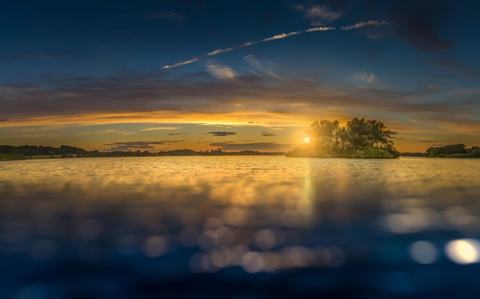Sunset over a lake with an island