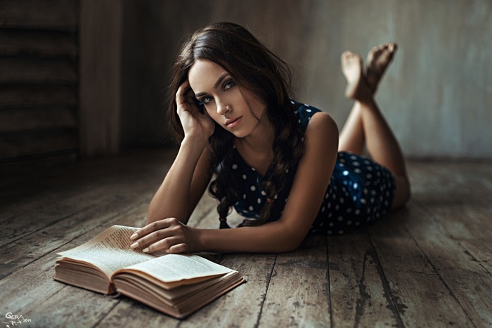 Woman Lying on Floor Reading a Book