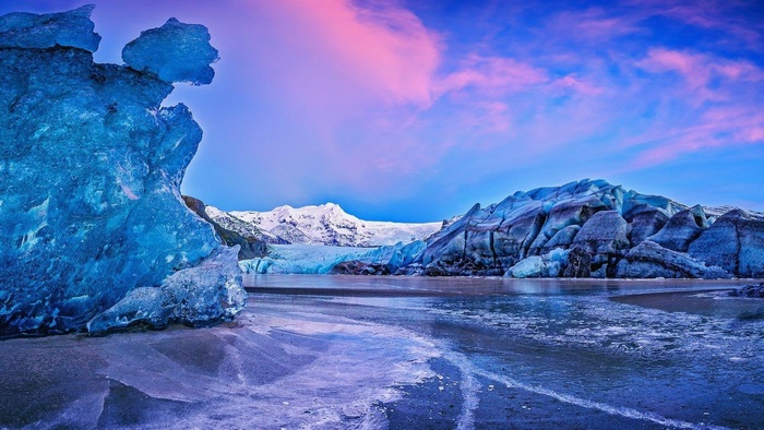 Glacier landscape with ice formations and mountains
