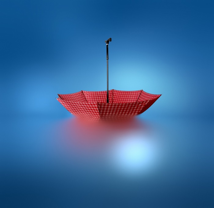 Red umbrella on blue background