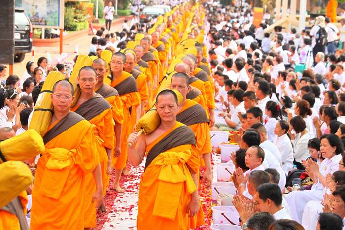 Buddhist monks in procession with devotees in Bangkok