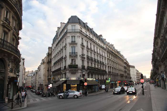 Parisian street with Haussmannian architecture and traffic