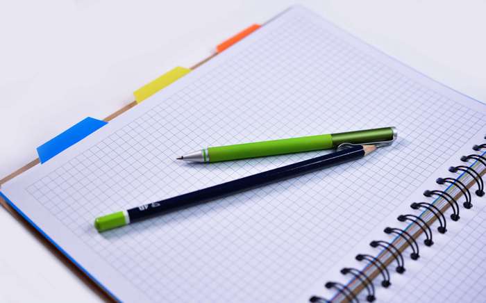 Notebook with pen and pencil