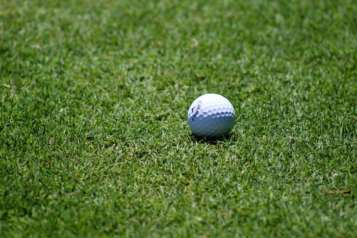 Golf ball on a green fairway 4K