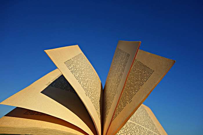 Open book against a blue sky