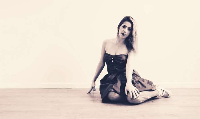 Woman in a dress posing on the floor