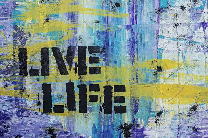Abstract painting with text "LIVE LIFE"
