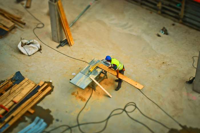 Construction worker using a table saw