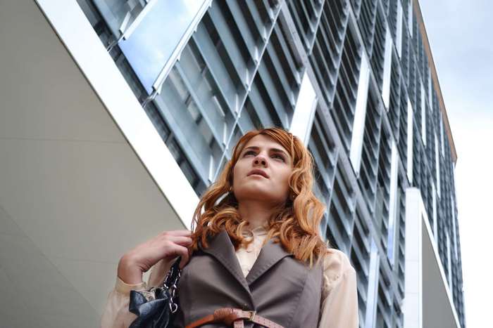 Woman in business attire in front of a modern building