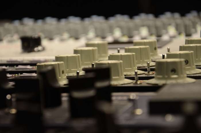 Close-up of audio recording equipment knobs