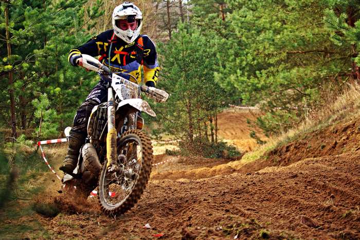 Motocross rider on a dirt bike in a forest