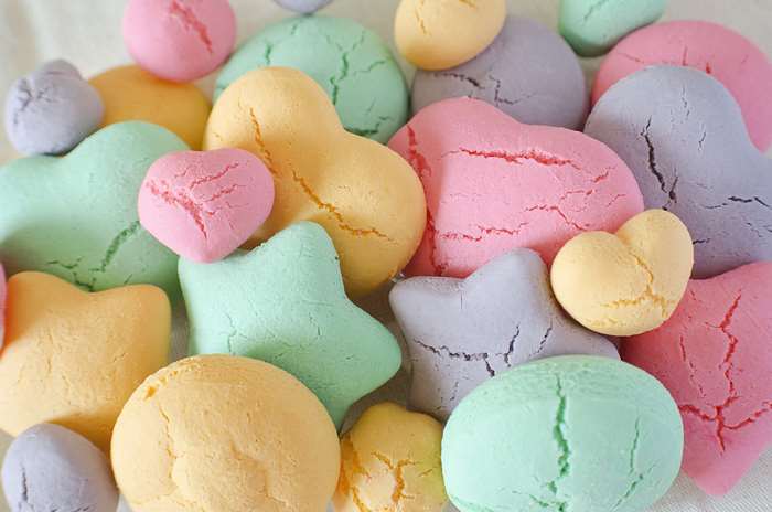 Assorted pastel colored cookies in heart and star shapes