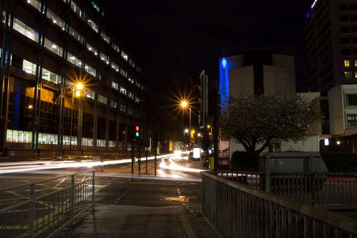 City street at night with light trails from cars