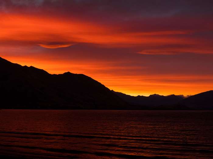 Silhouette of mountains over a lake at sunset