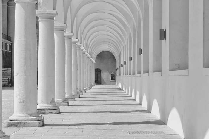 White arched colonnade with columns and shadows