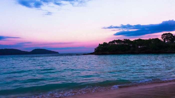 Beach at sunset with islands and ocean