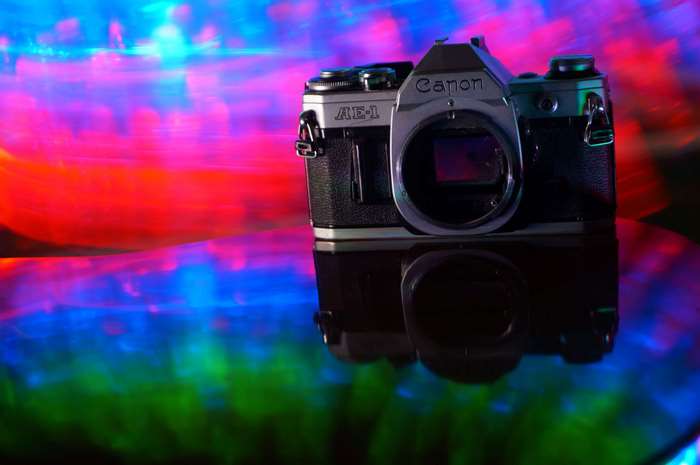 Canon AE-1 analog camera with abstract light reflections