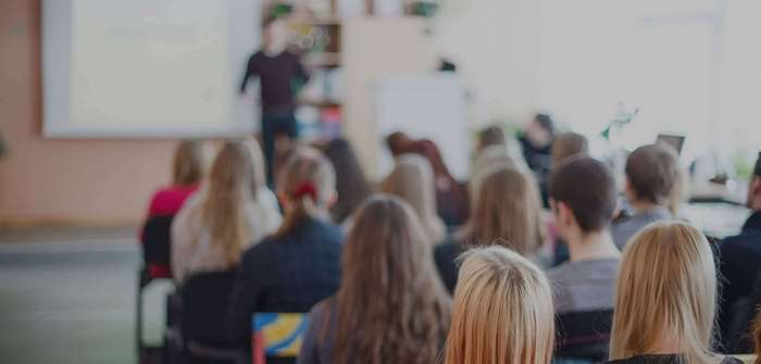Students in a blurred classroom during a seminar 4K
