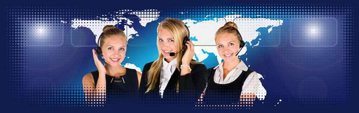 Three women in headsets with a world map background