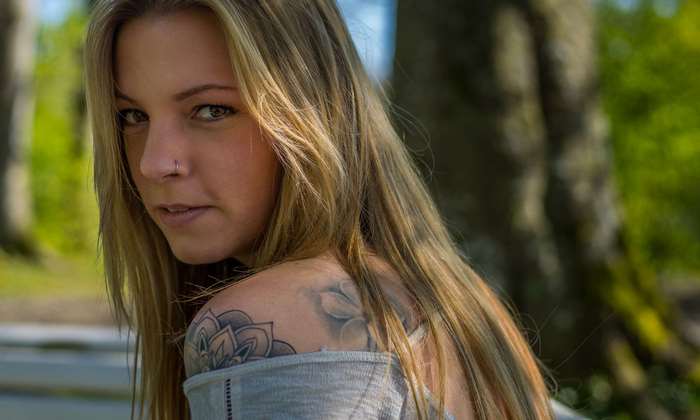 Young woman with blonde hair and tattoo