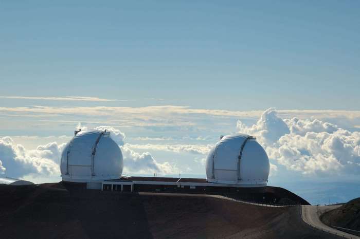 Mauna Kea Observatories with clouds and blue sky