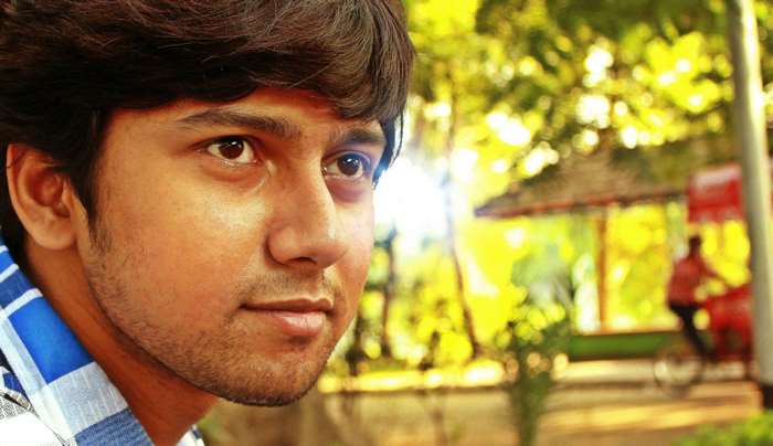 Close up portrait of a young Indian man outdoors