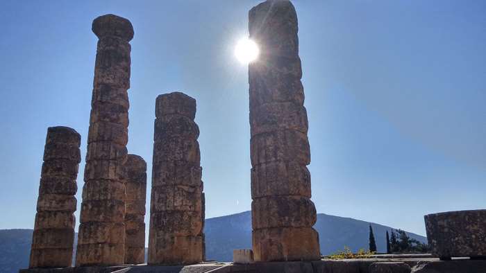 Ancient ruins of columns in Greece under the sun