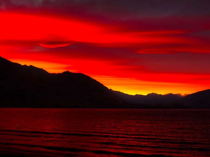 Fiery sunset over mountains and ocean
