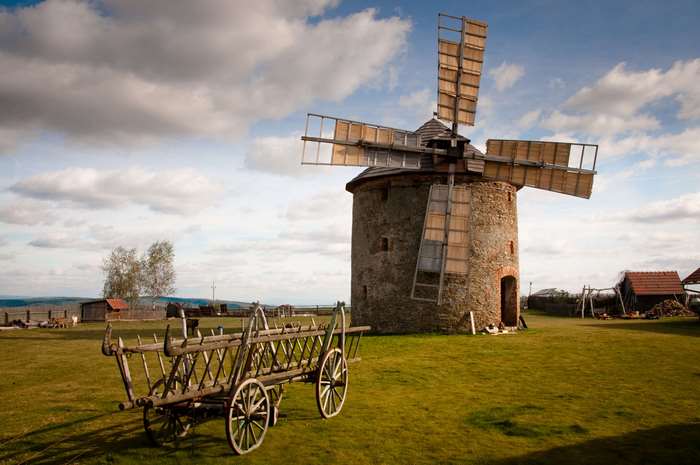 Old windmill and cart in a rural landscape