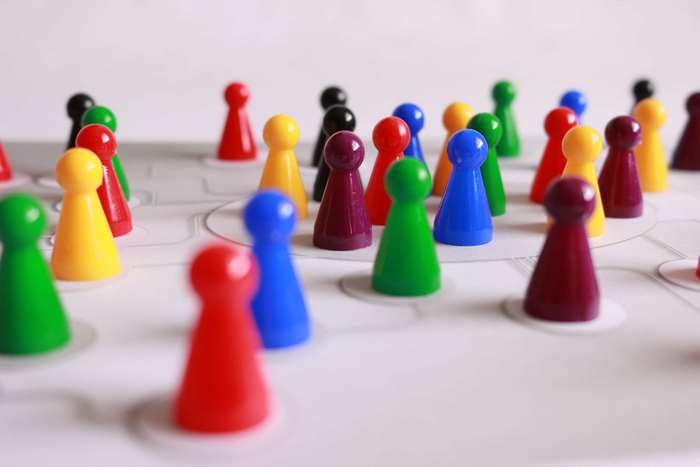Colorful game pawns on a board