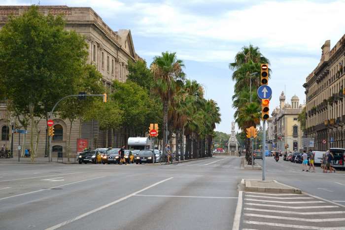 Street view in Barcelona, Spain with palm trees and traffic