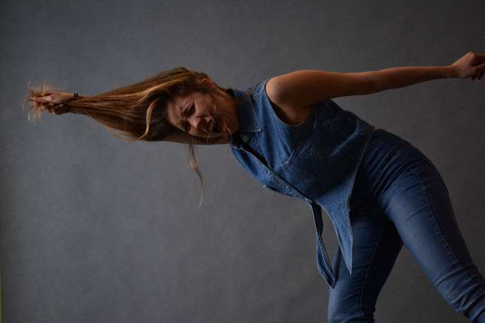 Young blonde woman in denim screaming