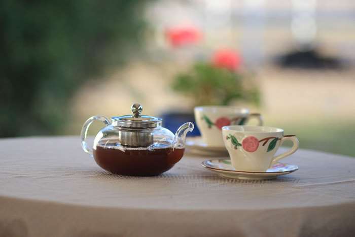 Glass teapot and teacups on a table