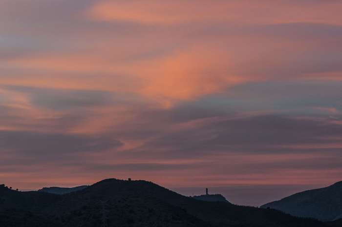 Sunset sky over silhouetted hills