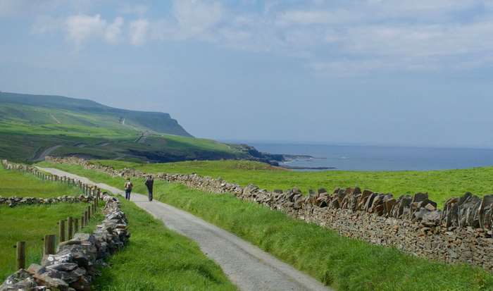 People hiking on a path along the Cliffs of Moher, Ireland 4K