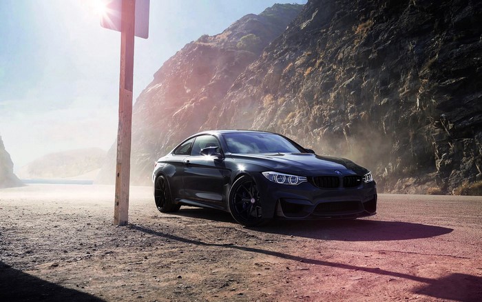 Black BMW M4 F82 parked on a dirt road