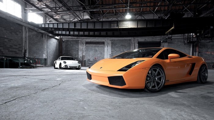 Orange Lamborghini and White Porsche in Garage