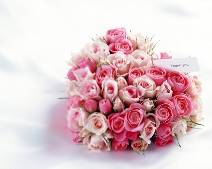 Bouquet of pink and white roses with a thank you card