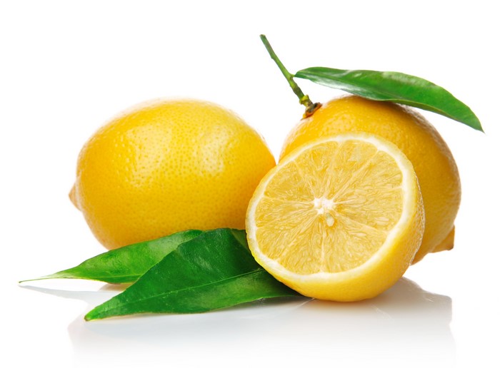 Lemons with leaves on white background