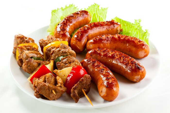 Sausages and meat skewers on a plate