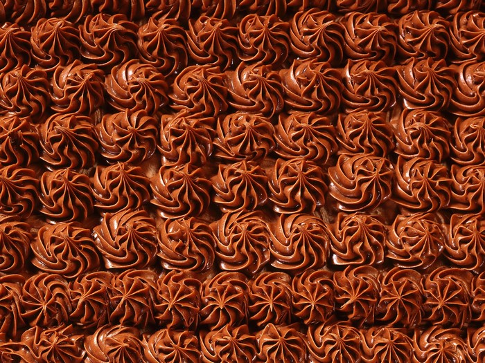 Chocolate frosting swirls on a cake